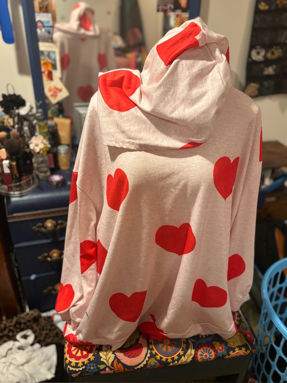 Oversized pink hoodie with red hearts.